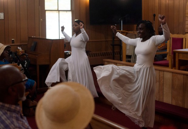 Sisters Iman, left, and Nia Fisher perform a dance during a dramatic presentation in Hossana A.M.E. Church on African American history at the 8th Annual Upper Bay Juneteenth Festival in Darlington. (John Gillis/Freelance)
