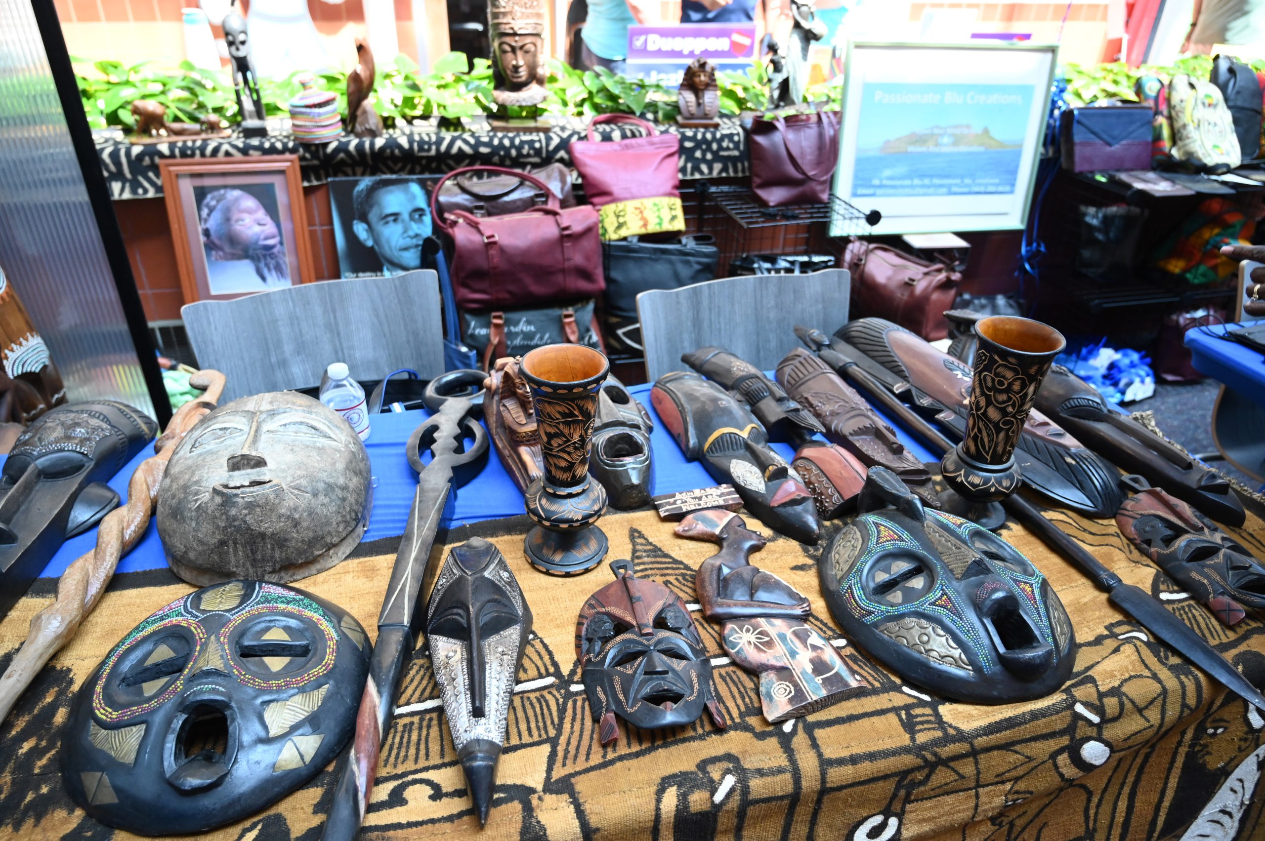 A collection of African artifacts are displayed on a table by Gail Satchell during the Juneteenth in Carroll celebration at Carroll Community College on Saturday. Satchell's business, Passionate Blu Creations, benefits a fresh water initiative to schools in Ghana through the sale of handmade bags, purses and more. (Brian Krista/staff photo)
