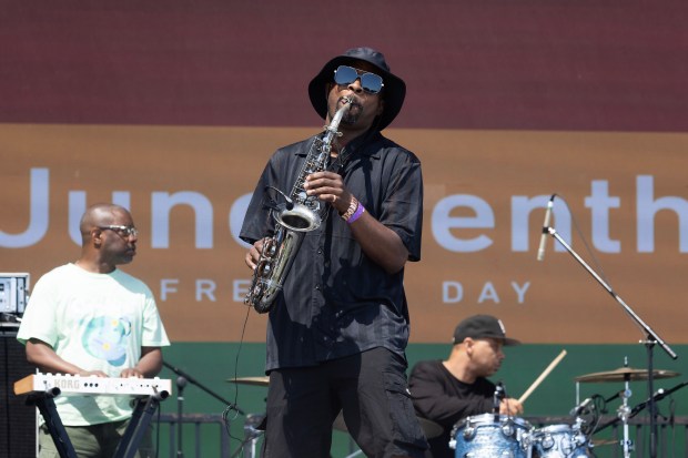 Reginald Paul, center, performs during Long Beach’s 4th annual Juneteenth...