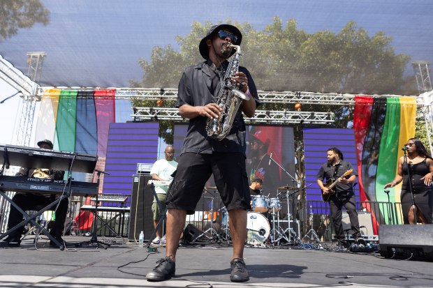 Reginald Paul, center, performs during Long Beach’s 4th annual Juneteenth...
