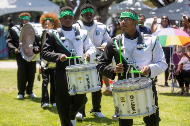 The Dorsey High School Drum-line and Drill Team perform during...