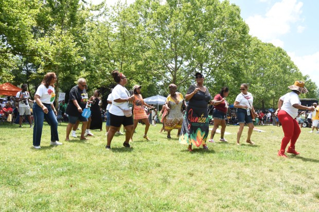People line dance in celebration of Juneteenth at the Village Initiative's Freedom Celebration in Williamsburg. Sam Schaffer/Staff