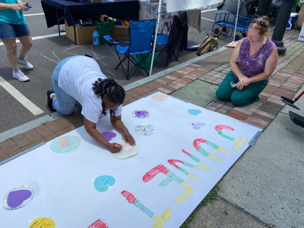 Marie Haigh, right, from Pottstown Community Arts, helped Paul Ingram...