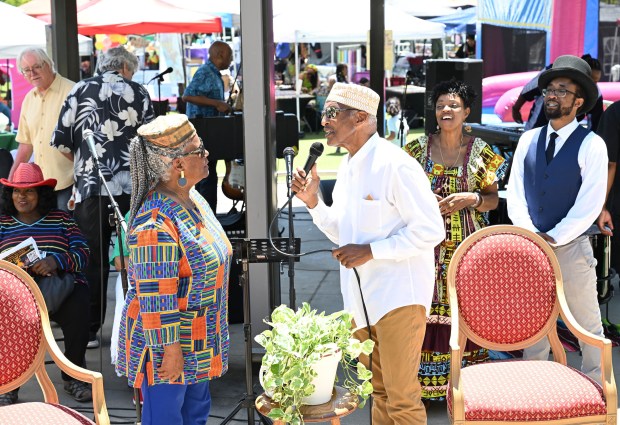 Community queen Jackie Dedrick, left, is sung to by her...
