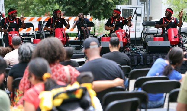 The Bucket Boys their show off their percussion skills during Oak Park's Juneteenth community cookout held on the south lawn of Village Hall Saturday, June 15, 2024, in Oak Park. (James C. Svehla/for Pioneer Press)