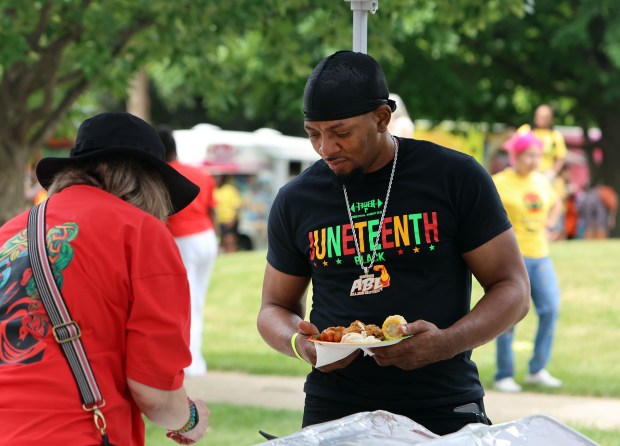 Marcellos Brown gets a plate full of food during Oak Park's Juneteenth community cookout held on the south lawn of Village Hall Saturday, June 15, 2024, in Oak Park. (James C. Svehla/for Pioneer Press)