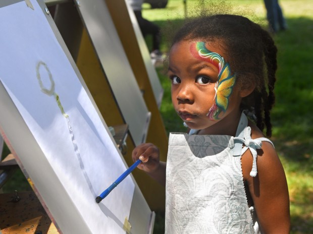 Niyah Hillyer, 4, paints during Redlands’ Juneteenth Festival on Sunday,...