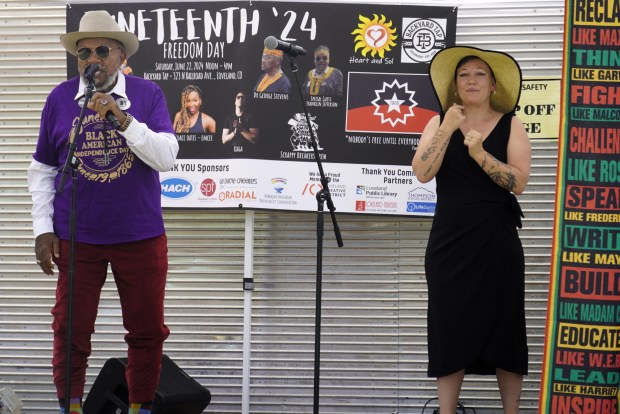 Franklin Jefferson, at left, shared memories of celebrating Juneteenth in south Texas during his childhood at Loveland's fourth annual commemoration of the historic event. Heart and Sol volunteer M.J. translated his remarks into American Sign Language.(Jocelyn Rowley/Loveland Reporter-Herald)
