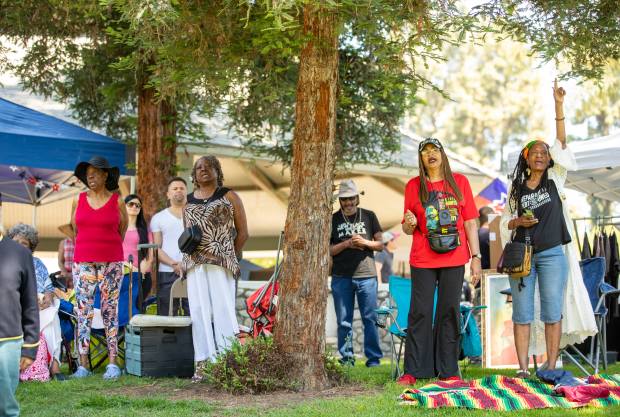 People sing to the Black national anthem during the 34th...