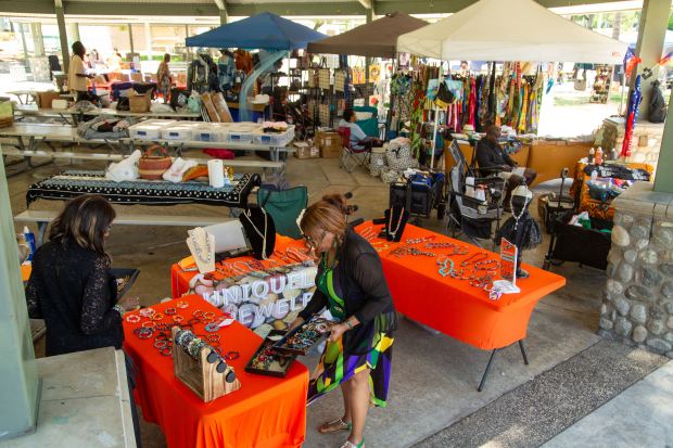 Vendors set up displays during the 34th Pomona Valley Juneteenth...