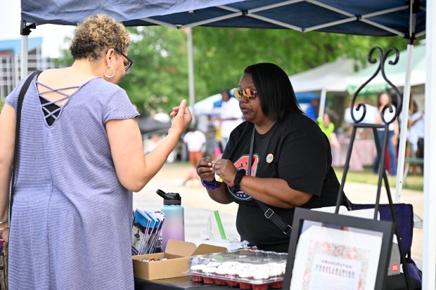 Kim Jones, left, welcomes Tabatha Garner to Juneteenth in Carroll 2023 at Carroll Community College on June 17, 2023. (Thomas Walker/freelancer)