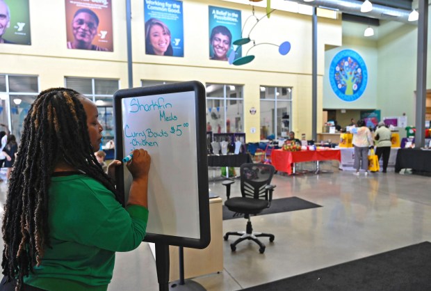 Catrina Springer, operations director of the Catonsville YMCA, writes out the menu for the center's Juneteenth event. (Kenneth K. Lam/Staff)