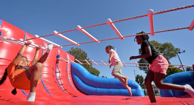 Children enjoy the inflatable area during the 4th Annual Juneteenth...
