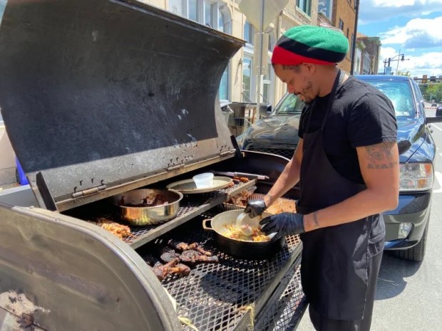 Jason Thomas, owner of Smokin' Jay's Caribbean Barbecue, was working hard filling orders during last year's Juneteenth celebration in Pottstown. (MediaNews Group File Photo)